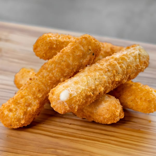 Golden-brown, crispy mozzarella sticks with melted cheese visible, piled on a wooden board at CARS Eatery.