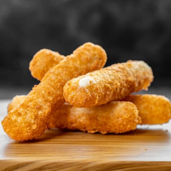 Golden-brown mozzarella sticks, one with melted cheese oozing out, on a wooden board at CARS Eatery.