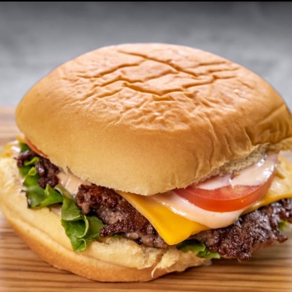 A delicious CARS Eatery fast-food burger with cheese, lettuce, tomato, and special sauce.